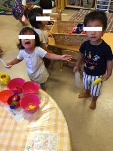 バナナの玩具を取られたことに気づいて泣く女の子。「泣くとは思ってなかった…」というような表情でしょうか。